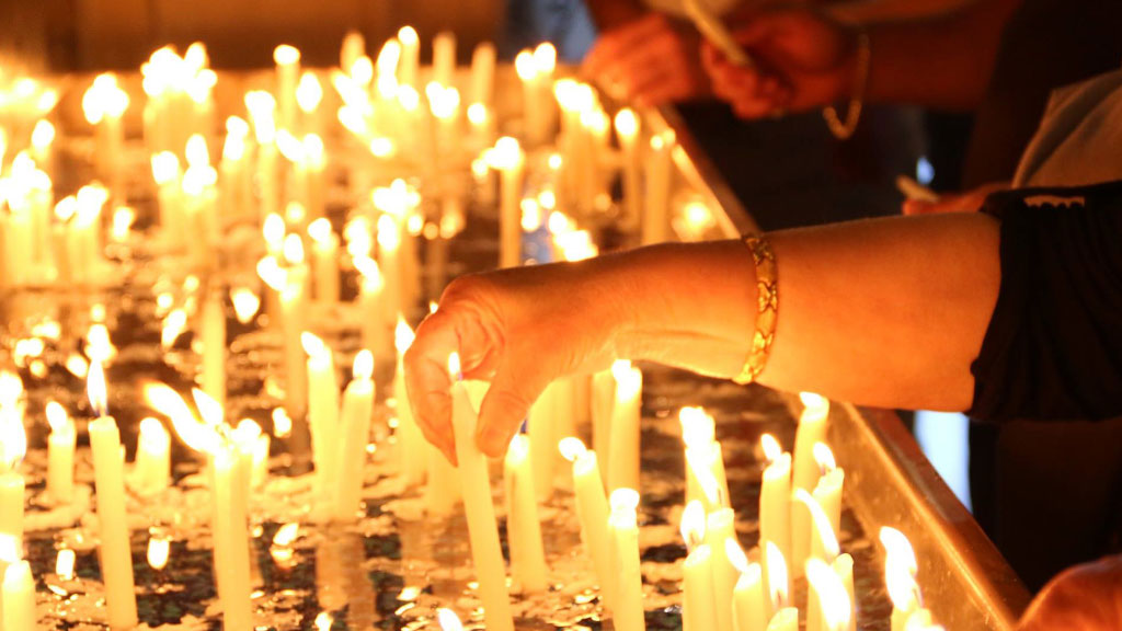 St. Mary's Armenian Apostolic Church Glendale, California. A place for prayer. Woman lighting candles.
